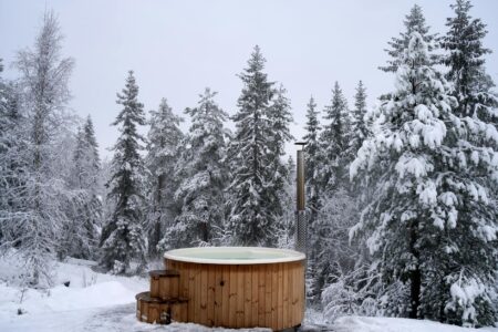 Person preparing to enter a cold plunge tub at a modern wellness studio