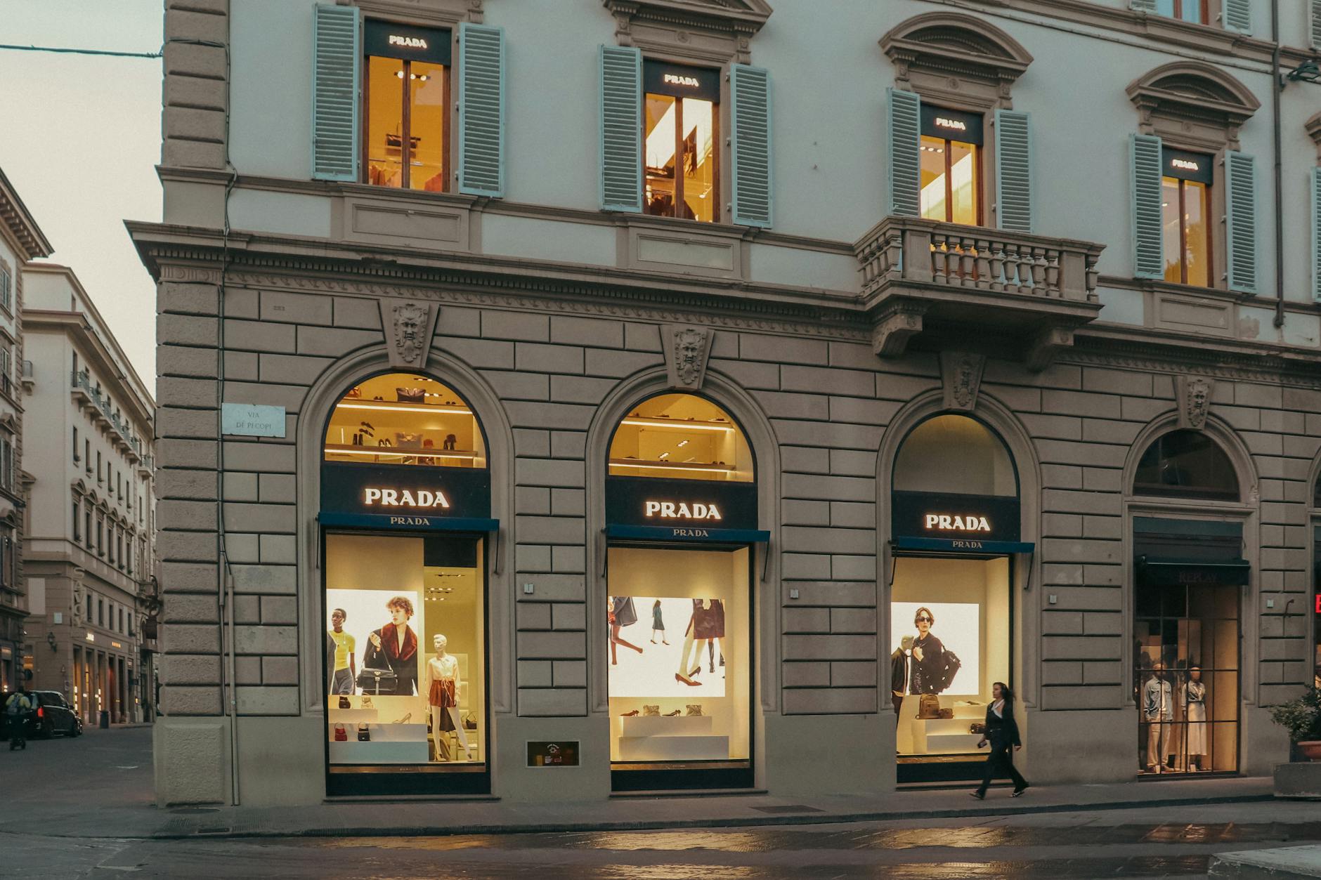 Interior of a minimalist luxury fashion boutique with sparse clothing displays