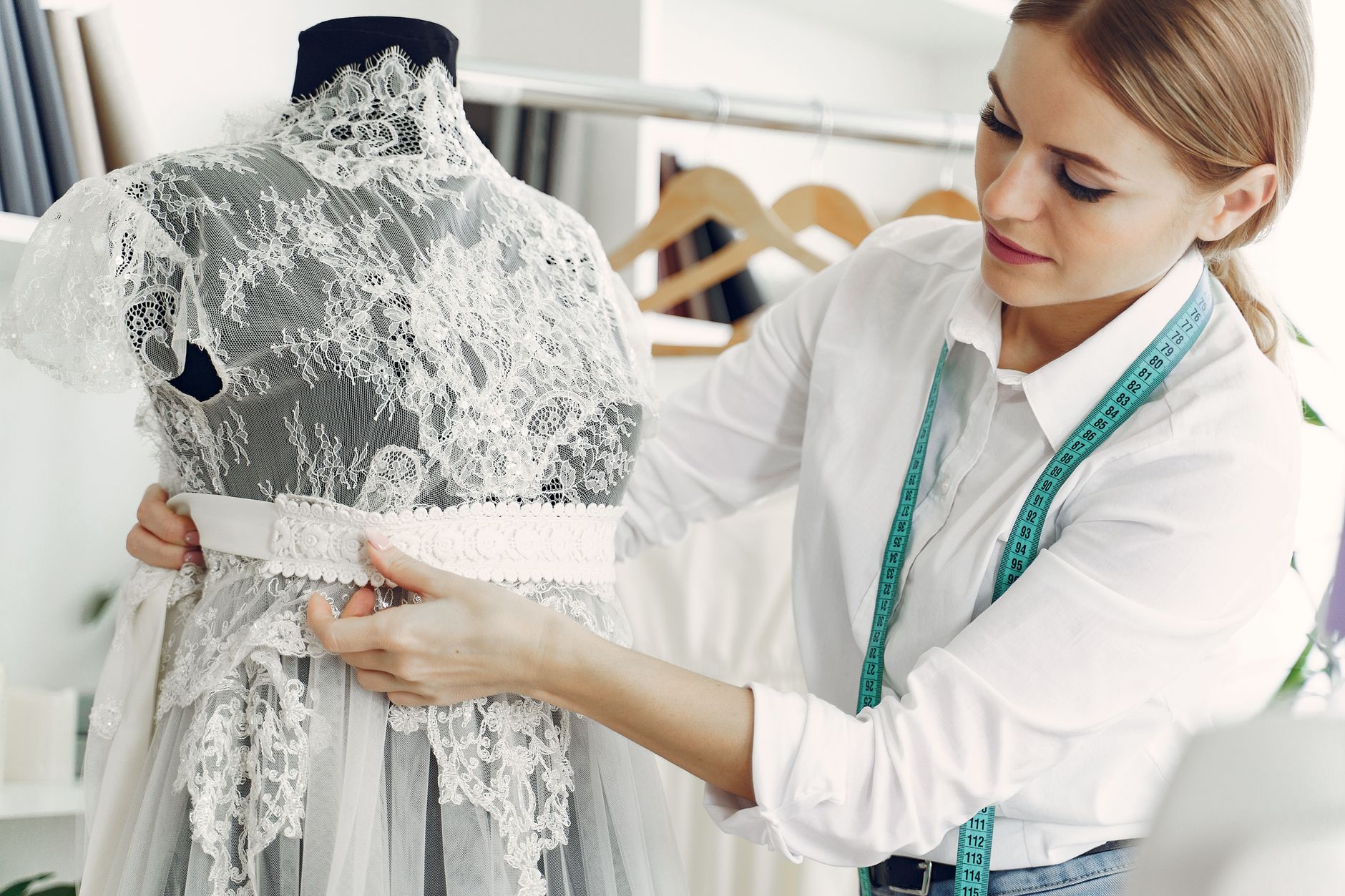 Interior of a high-end fashion atelier with garments on display and design materials visible