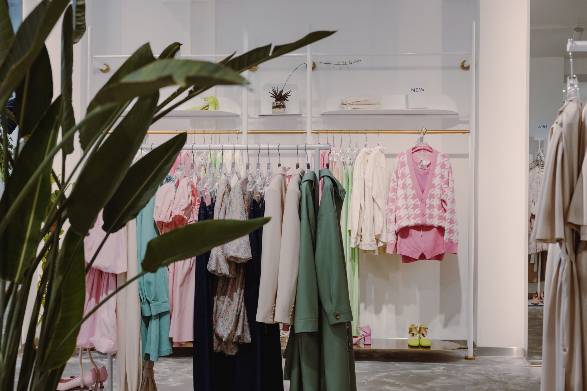 High-end fashion boutique interior with leather goods displayed on minimalist shelving