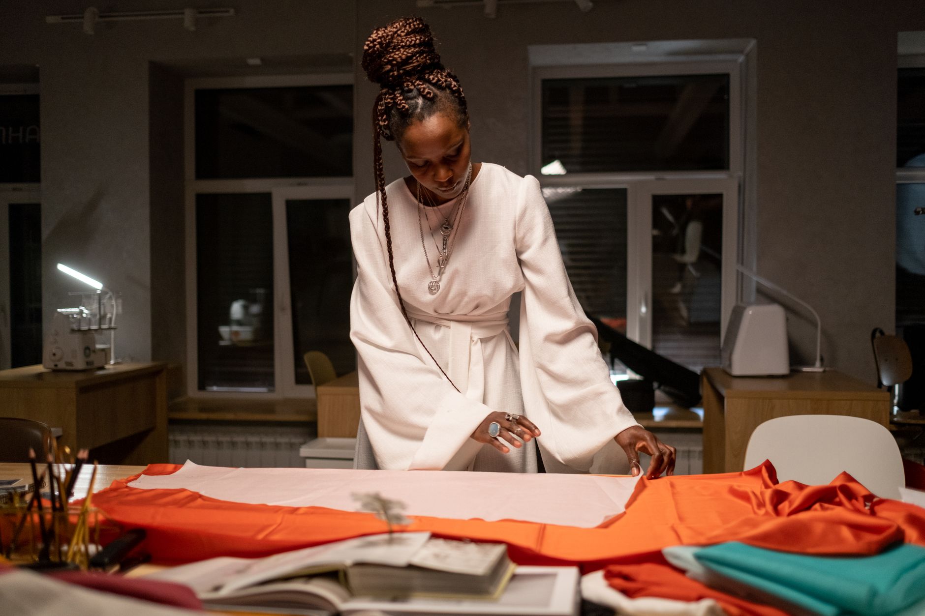 Fashion designer reviewing garments in a high-end atelier studio
