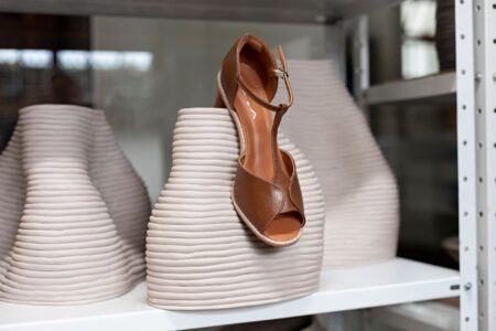 Close-up of minimalist luxury leather sandals on a clean surface
