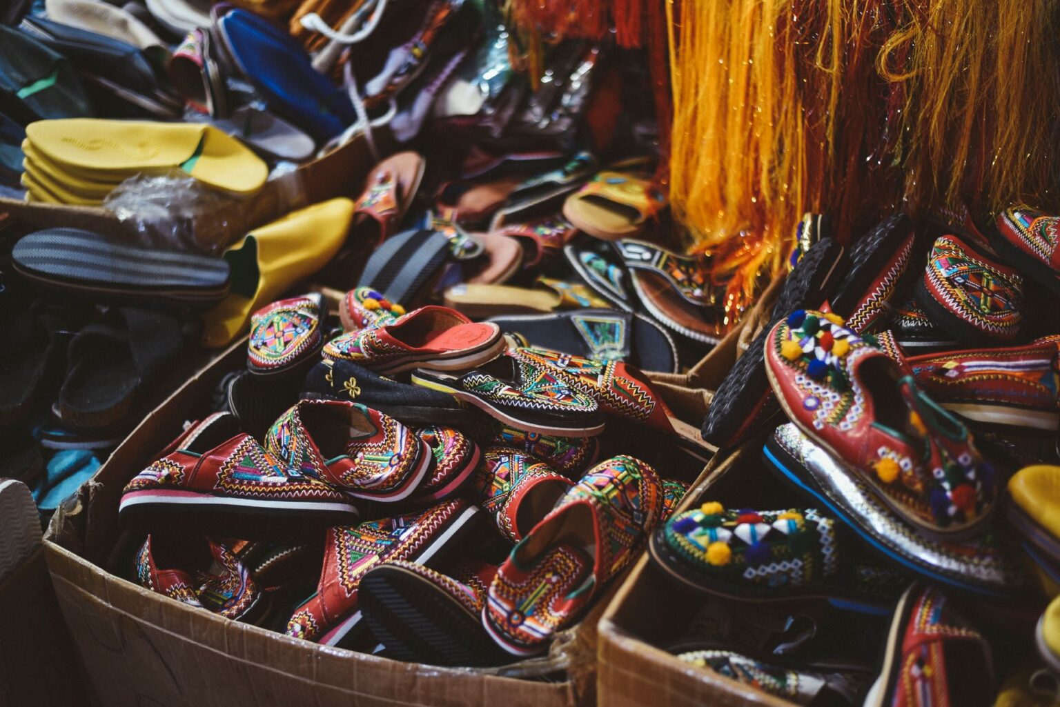 Close-up of woven leather mule shoes on a neutral background