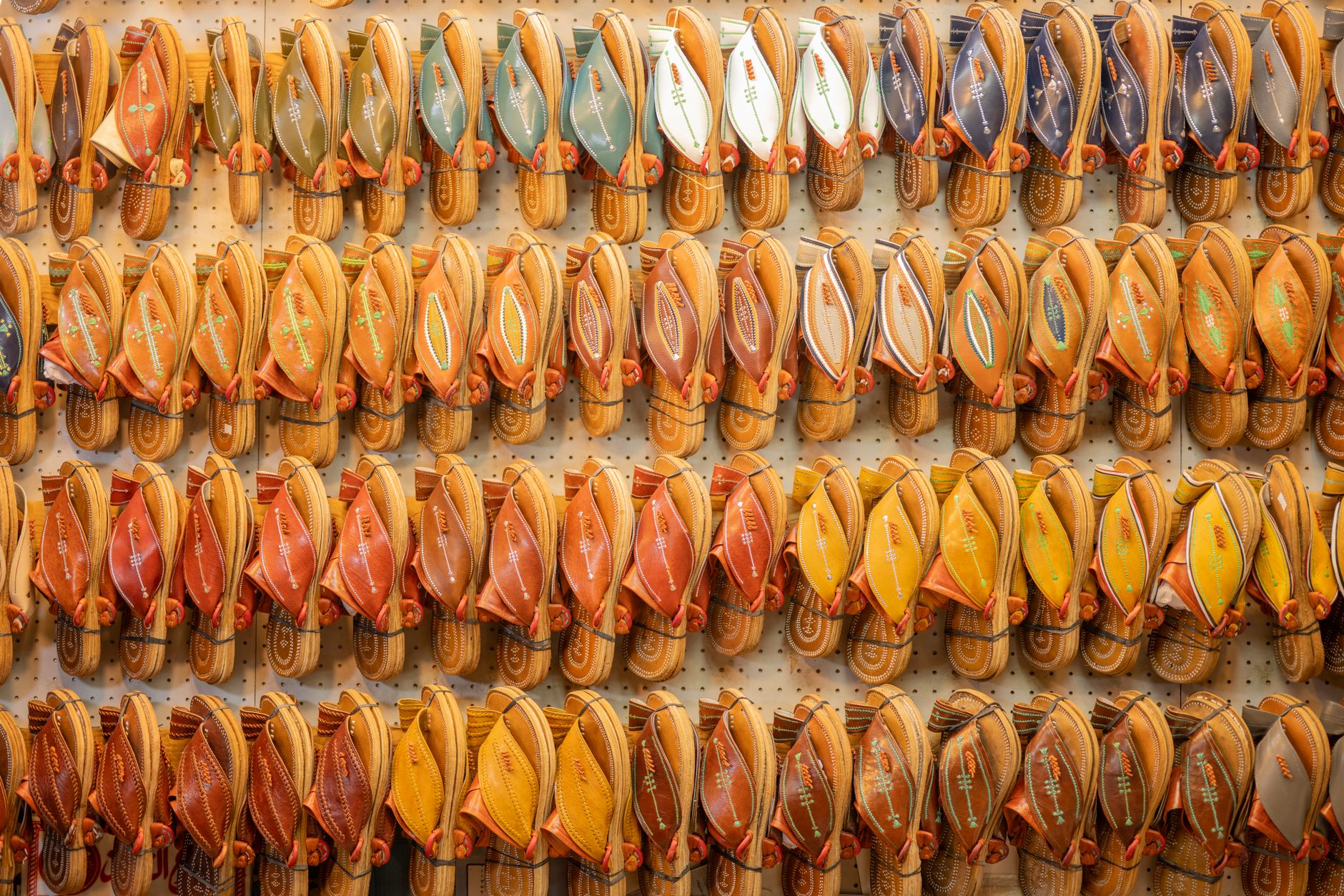 Close-up of a woven leather flat sandal on a clean surface