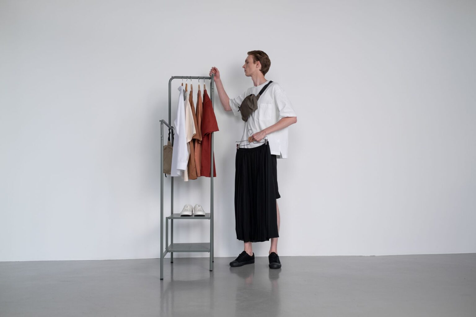 Minimalist fashion garments displayed on a clean rack, representing archival designer clothing