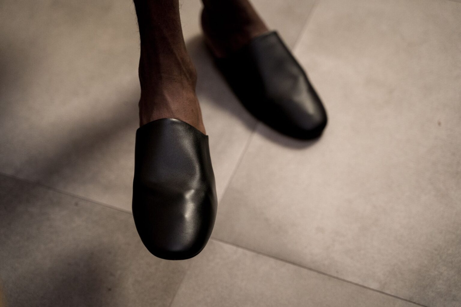 Close-up of minimalist leather flat shoes on a clean surface