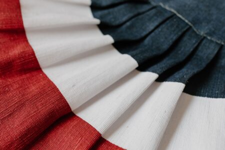 Close-up of pleated polyester fabric showing structured fold detail