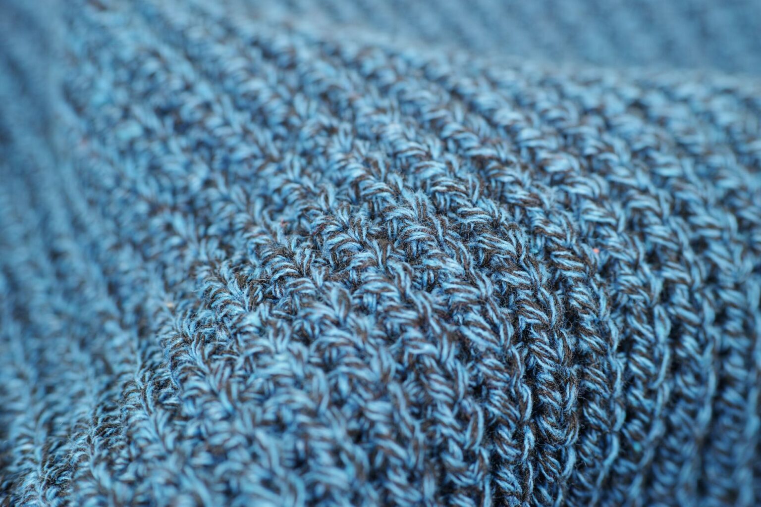 Close-up of fine-gauge knit mule shoes in neutral tone on a clean surface