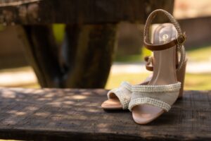 Close-up of wooden block-heel sandals on a neutral background