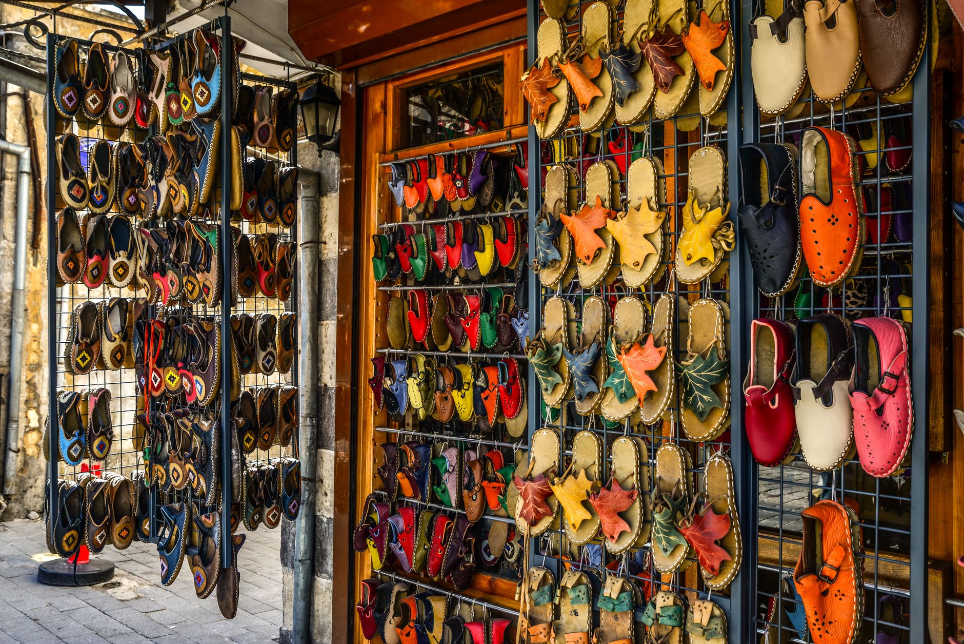 A retail display of casual slip-on shoes including mule and clog styles