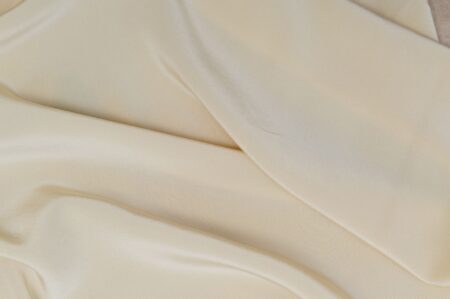 A fluid silk midi skirt in a rich tone, showing natural movement and drape