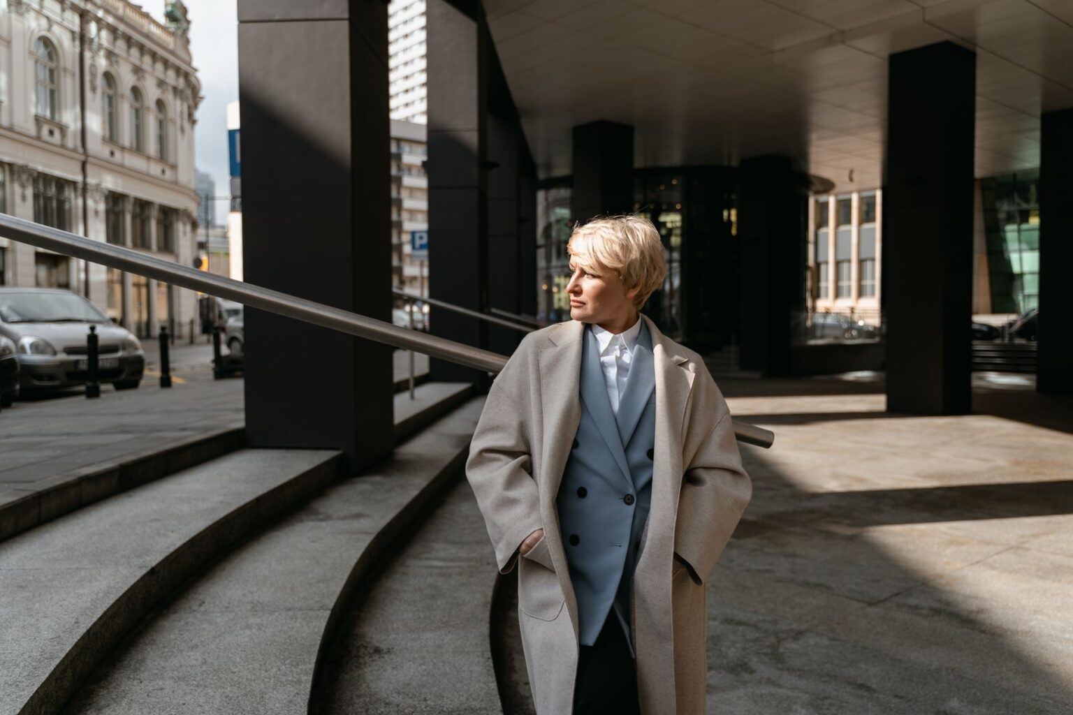 Model wearing a structured oversized drop shoulder coat in neutral tones