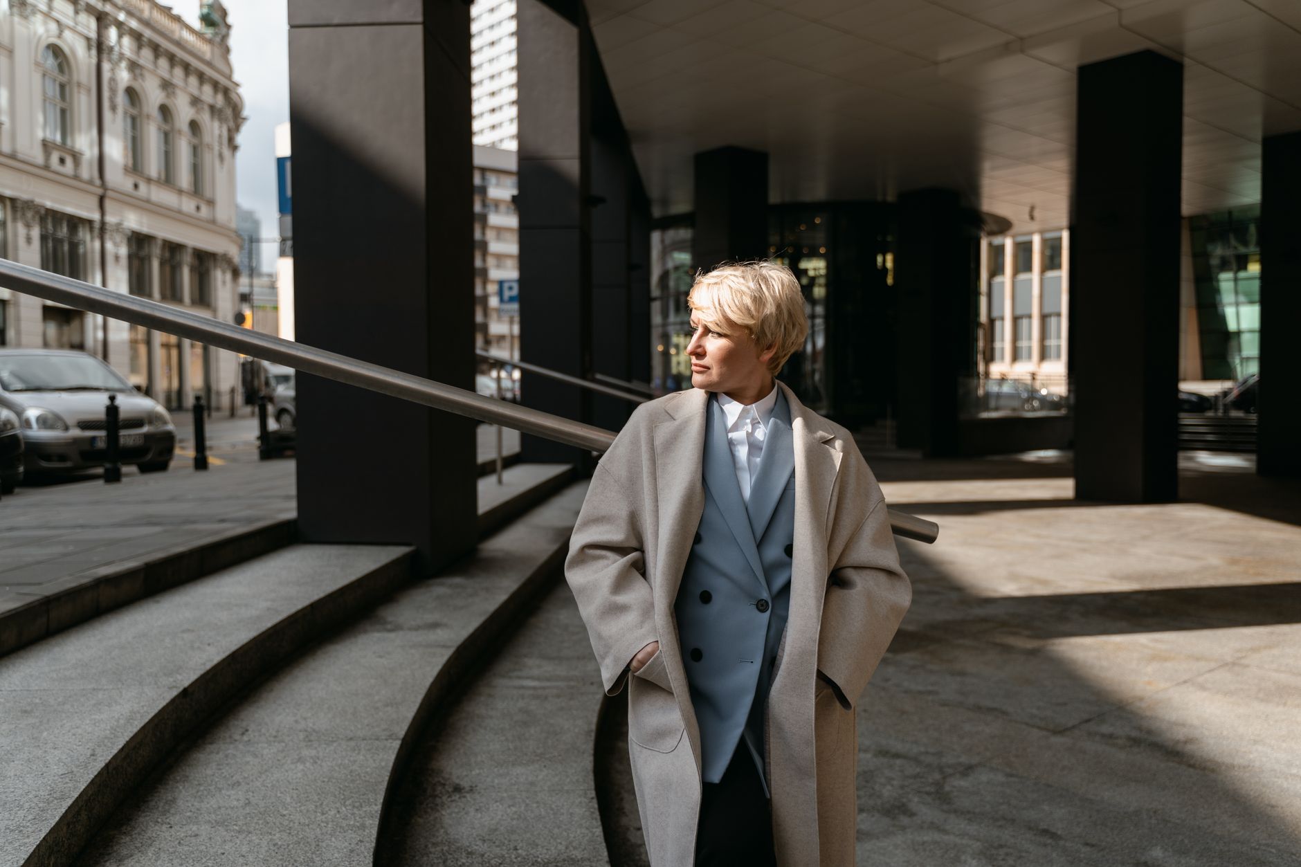 Model wearing a structured oversized drop shoulder coat in neutral tones