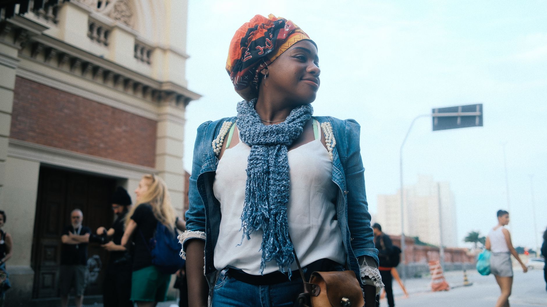Stylish woman walking in a city wearing a tailored outfit and flat shoes