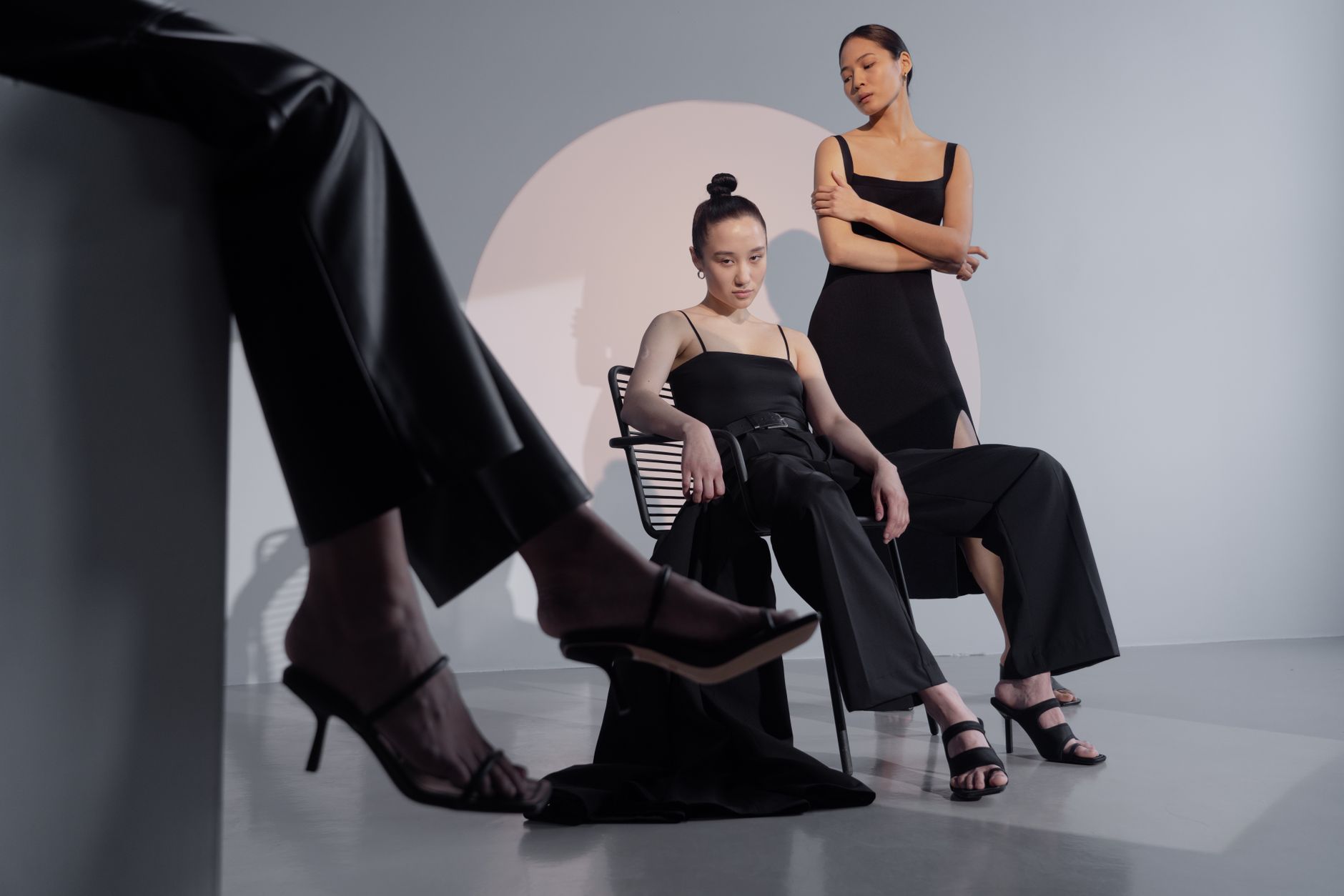 Clean studio setting with minimalist fashion garments displayed on rack