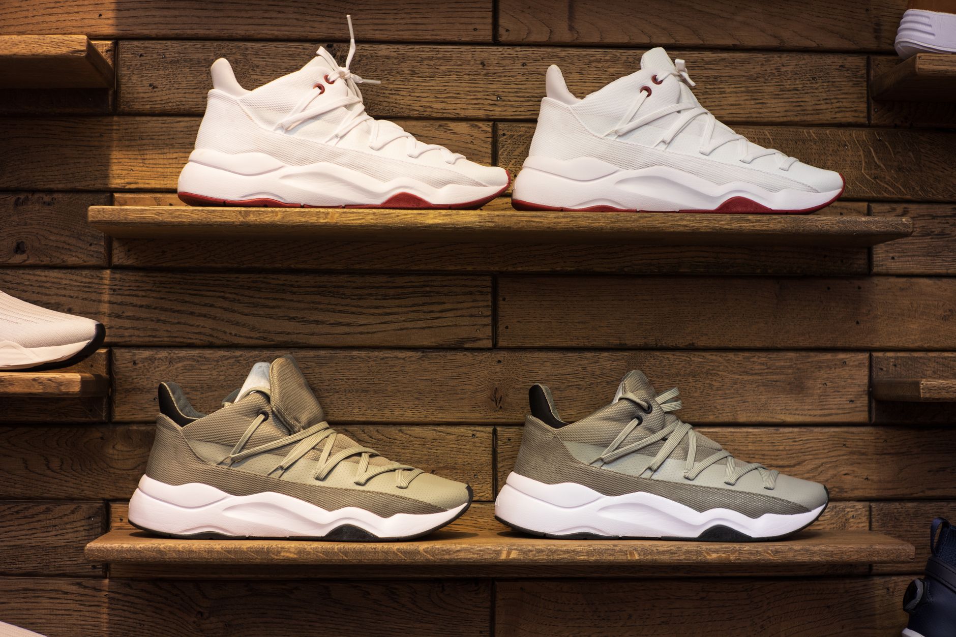 Luxury designer shoes displayed on a clean shelf in a high-end boutique setting