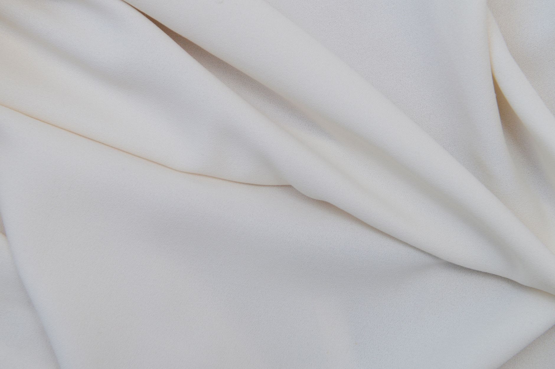 Soft cashmere fabric in neutral tones showing fine textile detail