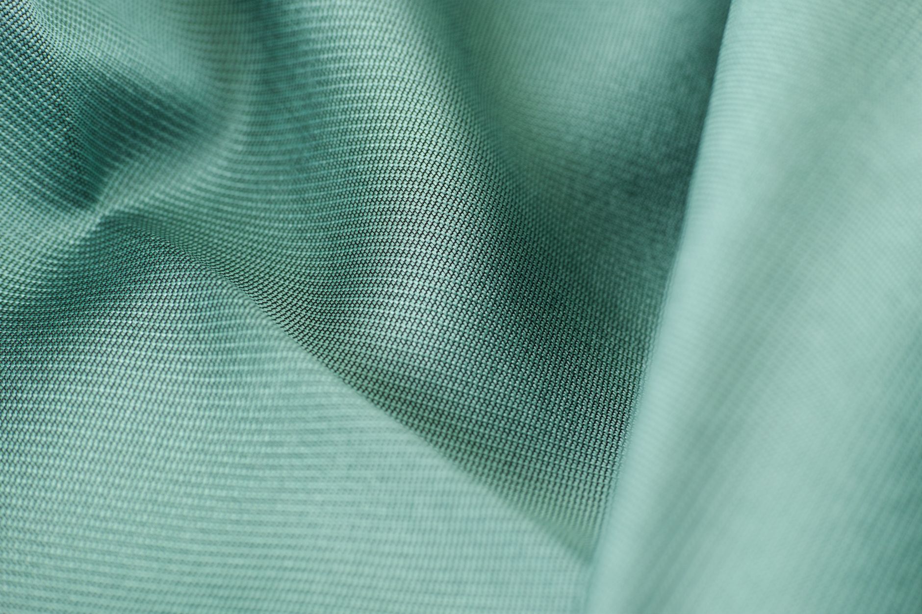 Detailed close-up of a tightly woven twill fabric showing texture and structure