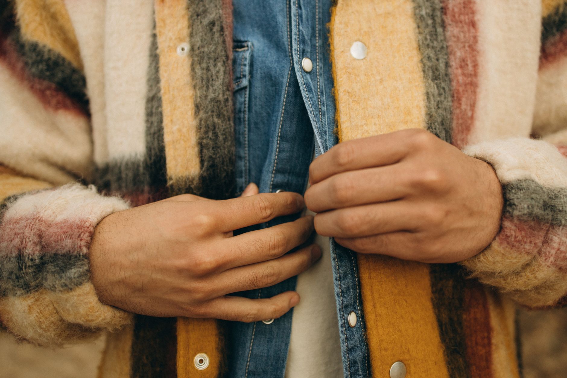 Close-up detail of a heavy structured jacket shoulder and drape