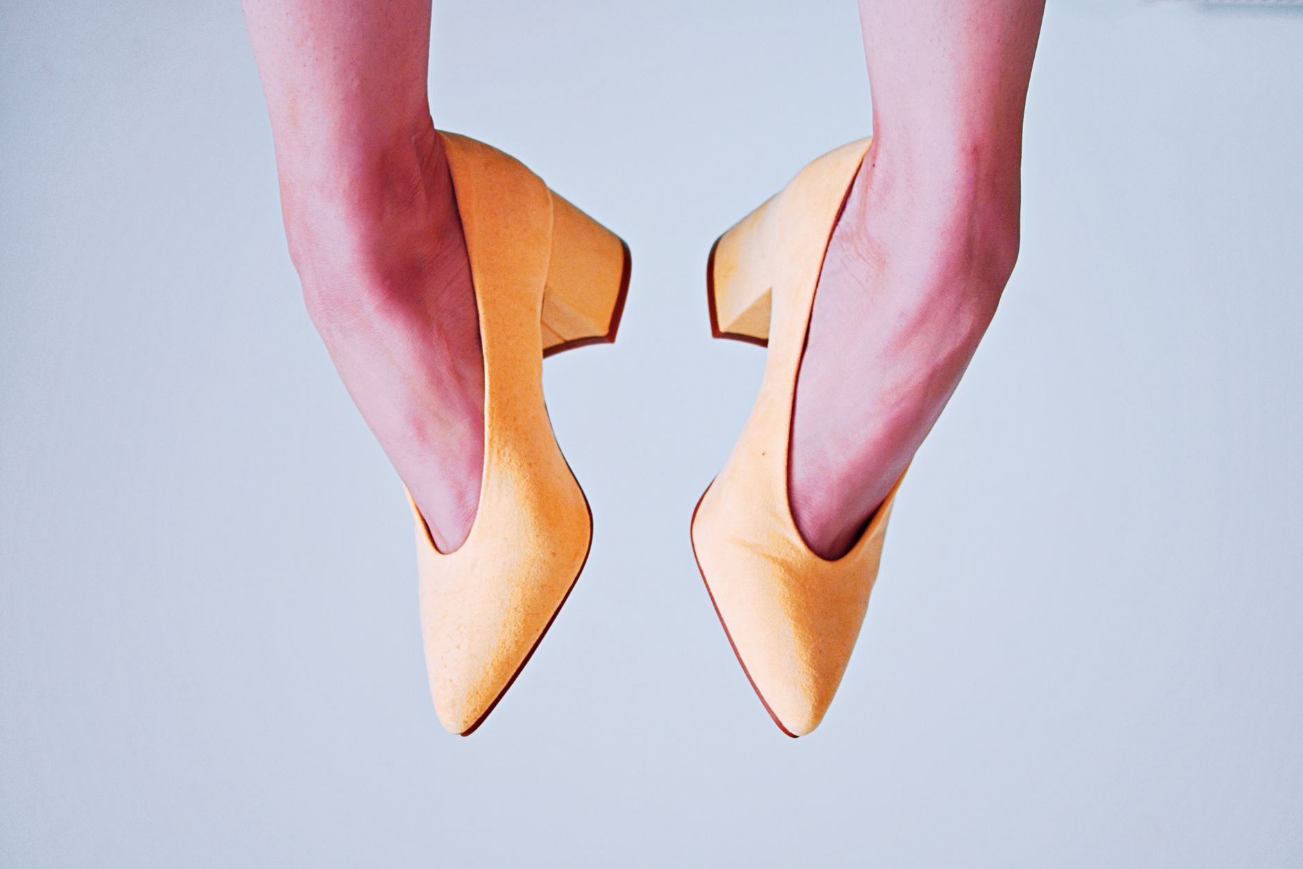 Woman wearing sleek heels styled with tailored trousers