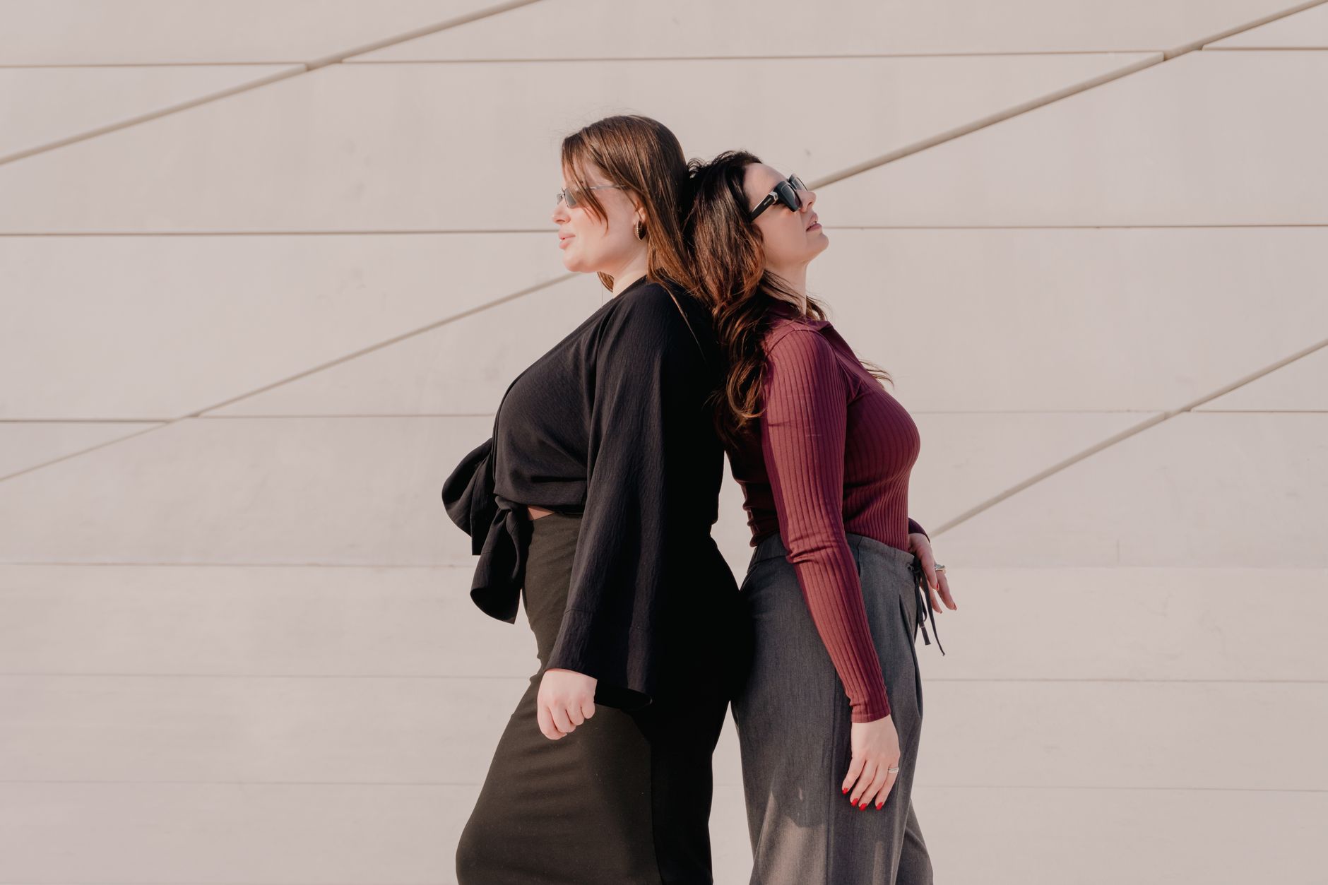 Woman in a minimal, understated outfit with flat shoes completing the look