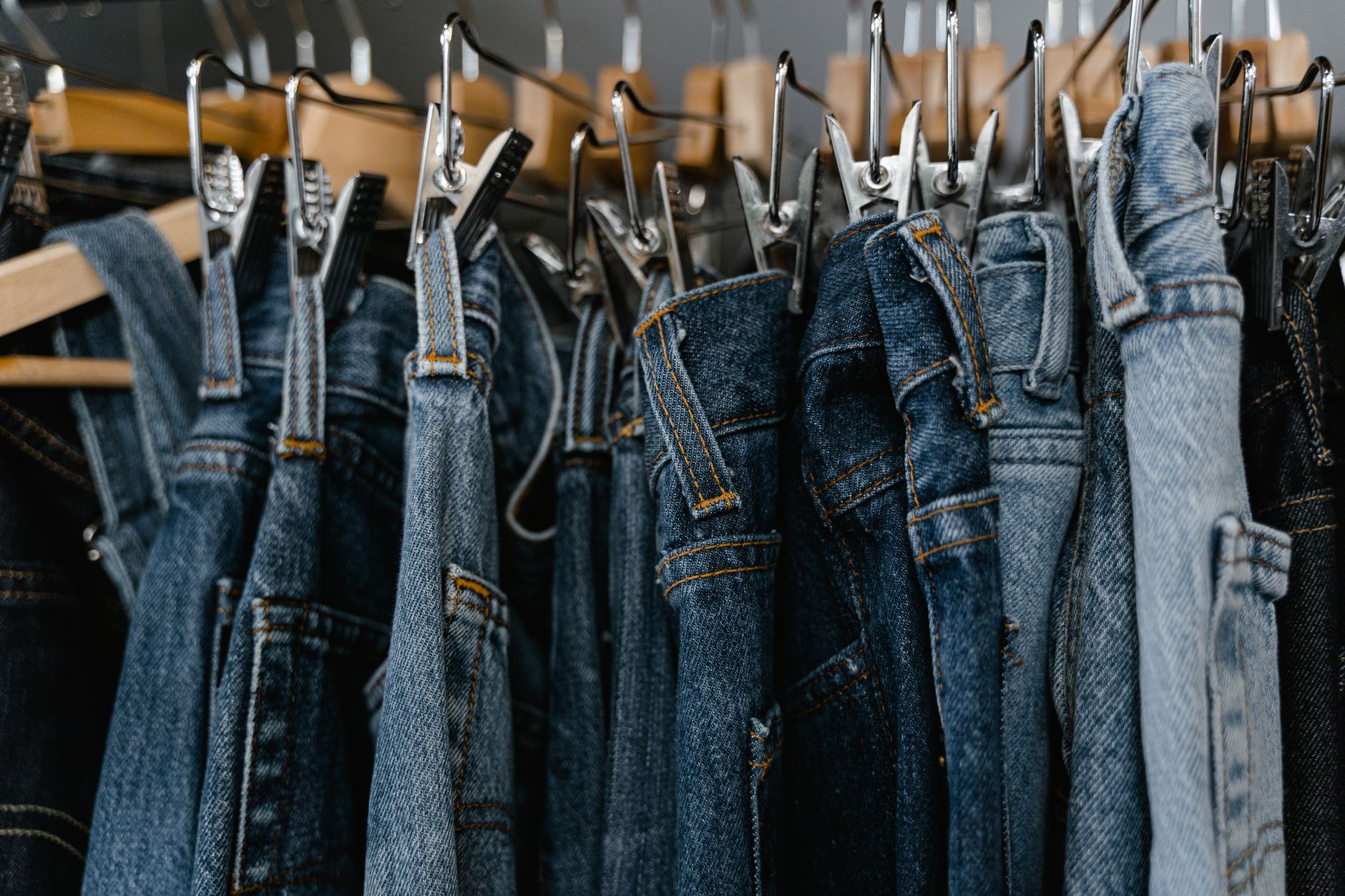 Vintage denim pieces folded and displayed in a resale fashion store