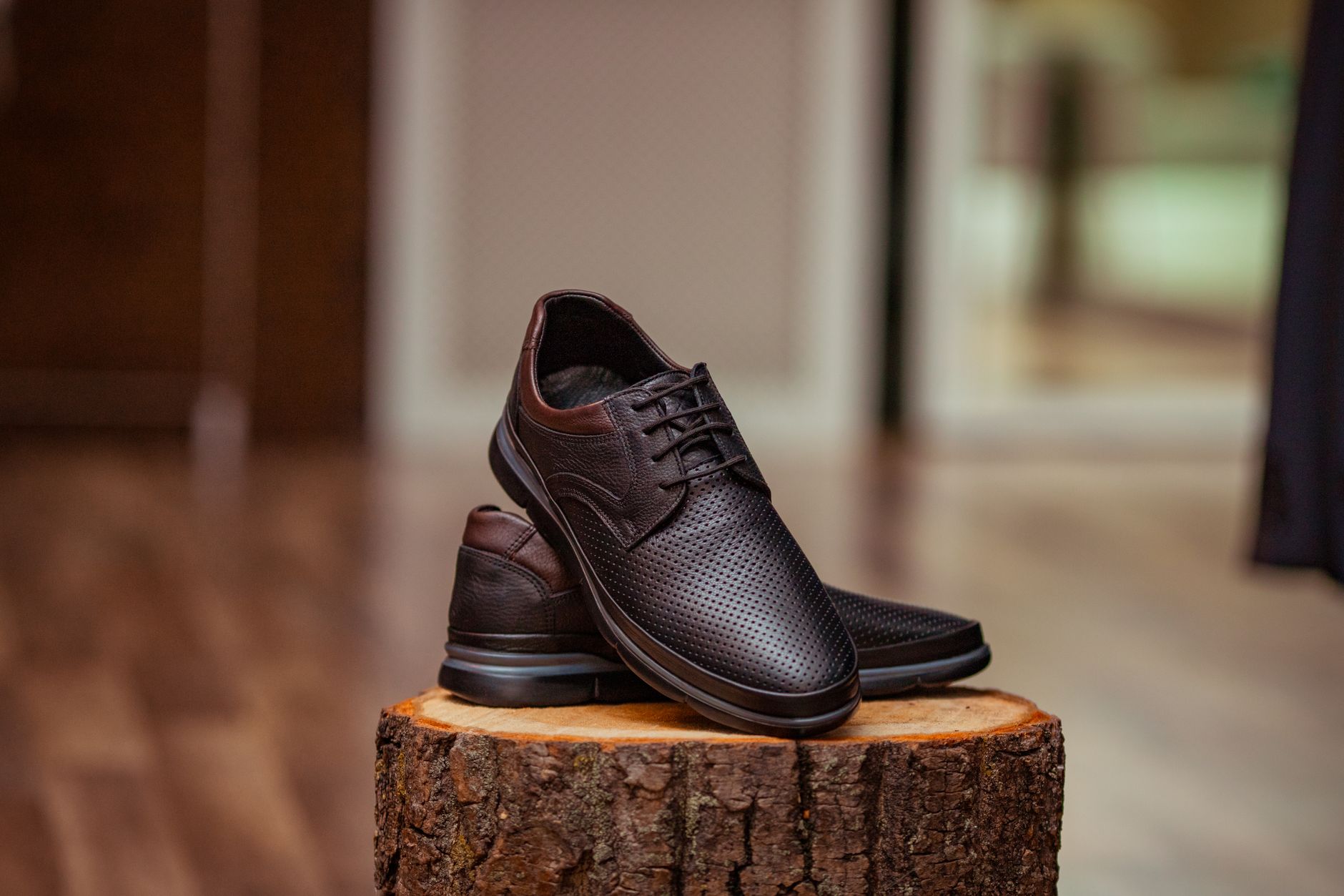 Elegant shoes displayed on a minimal shelf in a high-end boutique setting