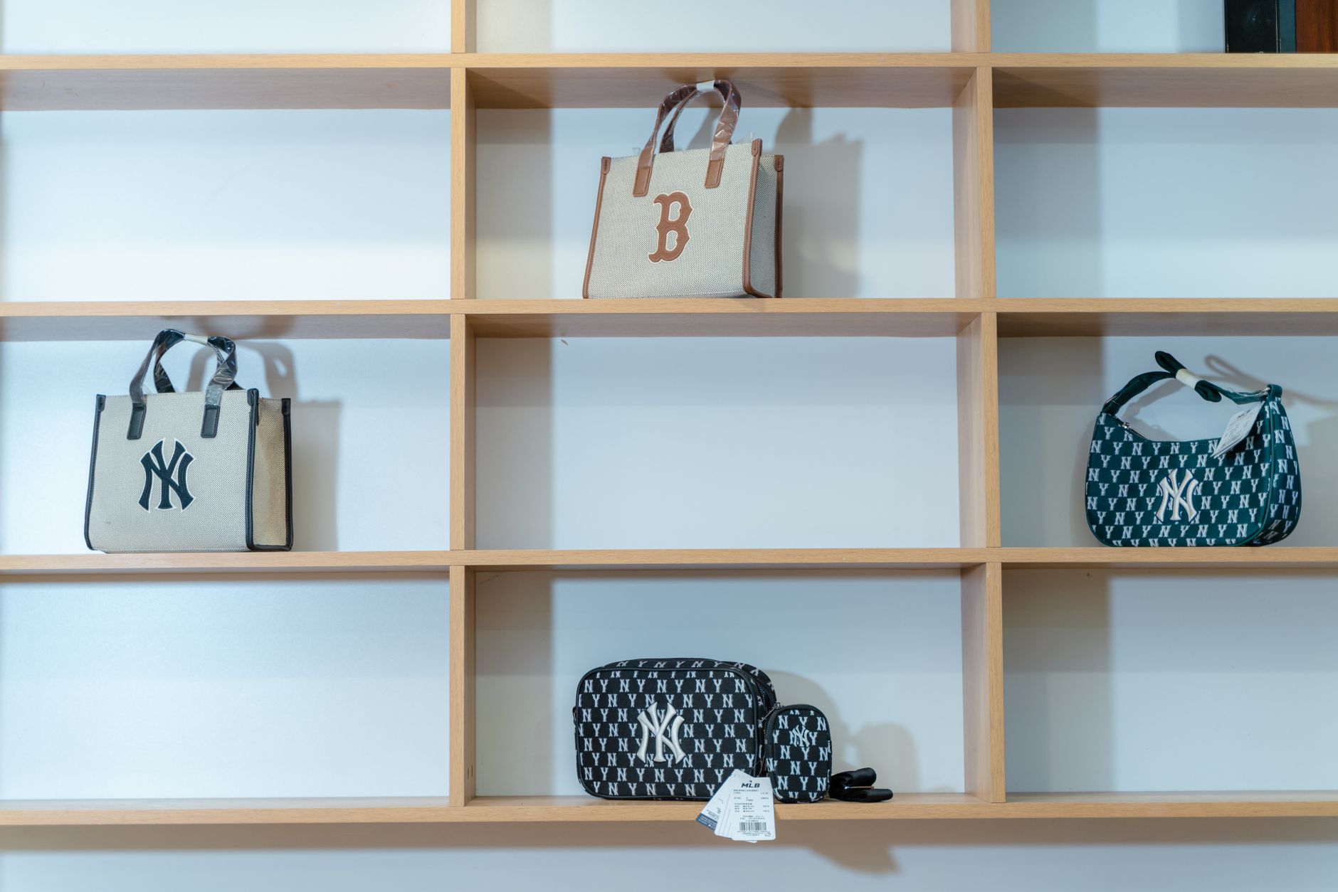Designer handbags arranged on a boutique display shelf