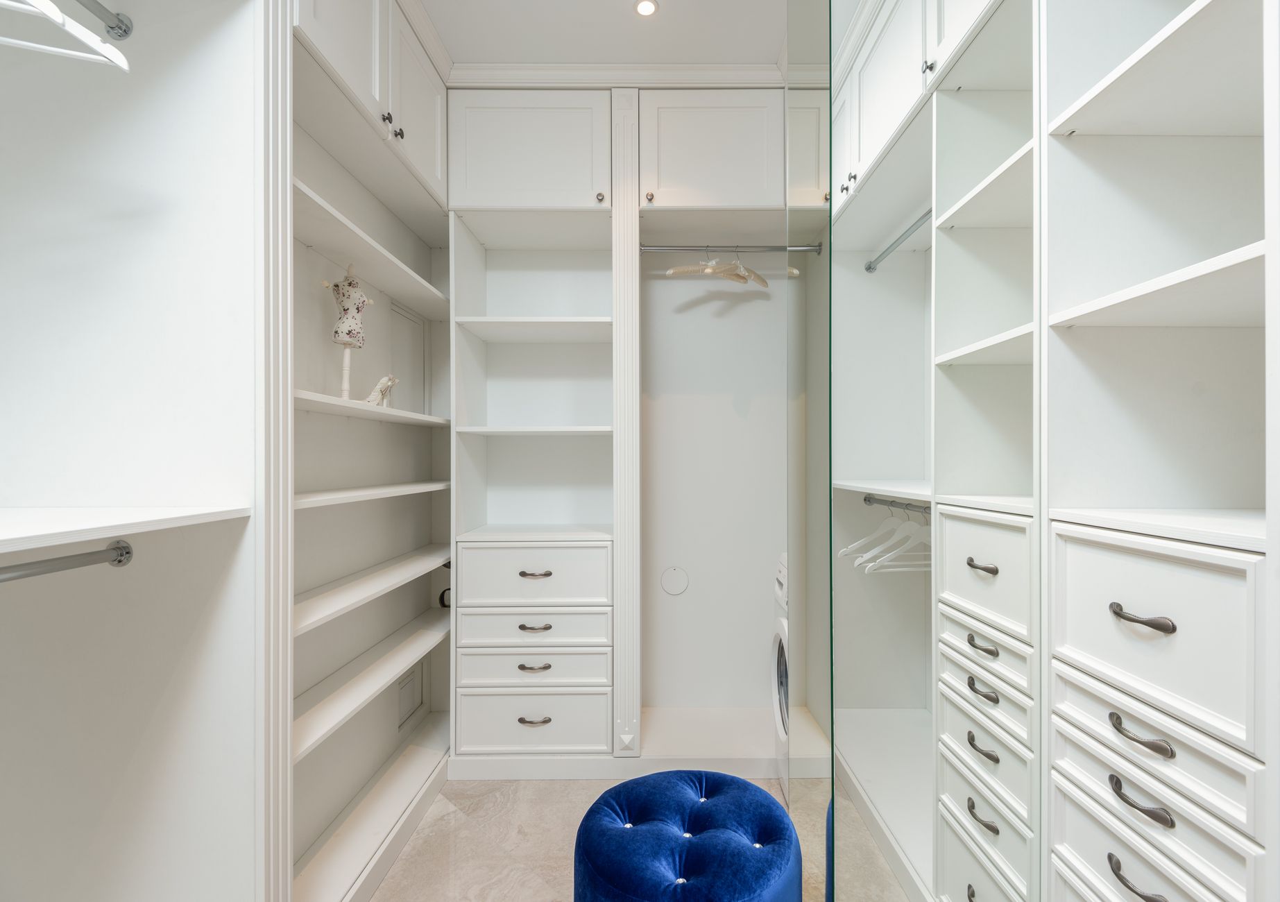A well-organized wardrobe with structured suits and minimal garments