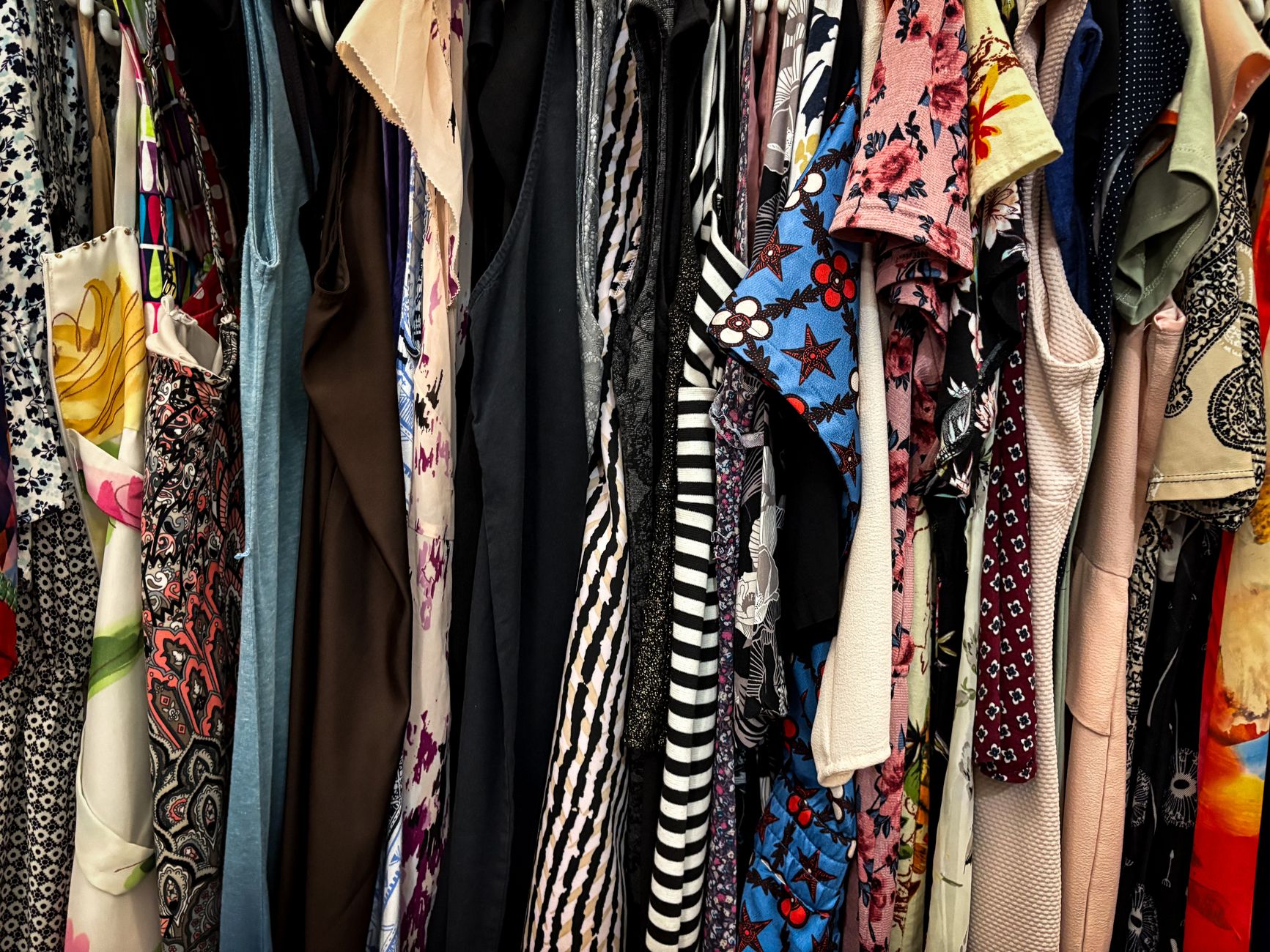 Close-up of mixed print garments with contrasting geometric and floral patterns