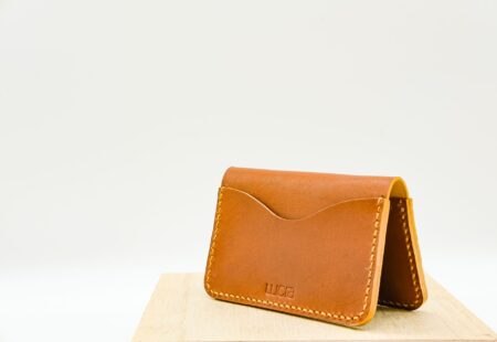 Bottega Veneta’s Intrecciato Wallet Is Quietly Unseating the Card Case A luxury leather bifold wallet placed on a clean surface, showing fine leather texture and craftsmanship