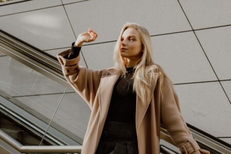 Toteme’s Straight Coat Is Quietly Outlasting the Wrap Coat A clean-cut straight wool coat hanging on a rack in a minimalist fashion setting