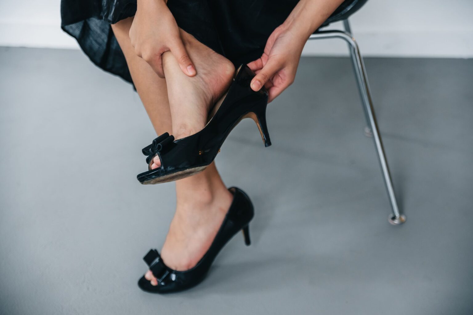 Close-up of kitten heel mule shoes on a polished surface
