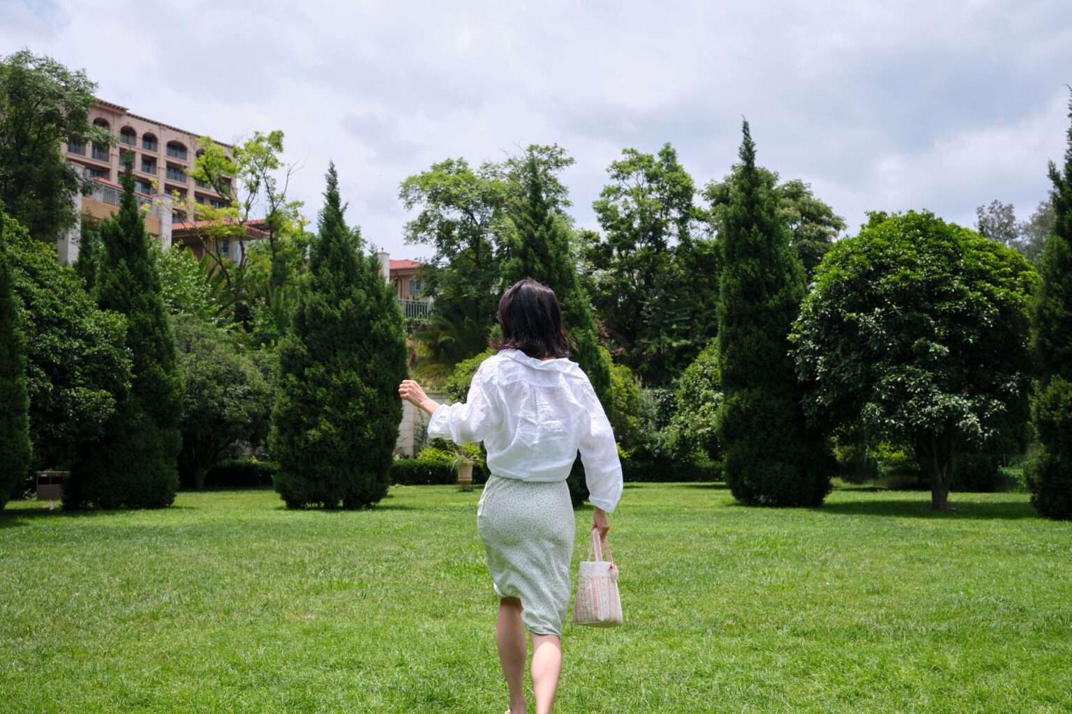 The Broderie Anglaise Skirt Is Quietly Edging Out the Linen Midi A white broderie anglaise midi skirt with delicate eyelet embroidery detailing, laid flat or worn casually outdoors