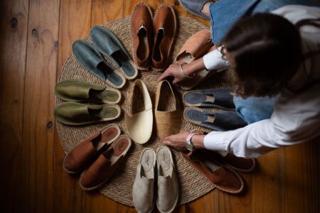 Neutral-toned flat shoes with ribbon detail arranged on a clean surface