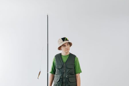 Person wearing a neutral-toned fisherman cap on a city street