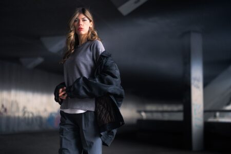 Person wearing an oversized shirt jacket as an outer layer on a city street