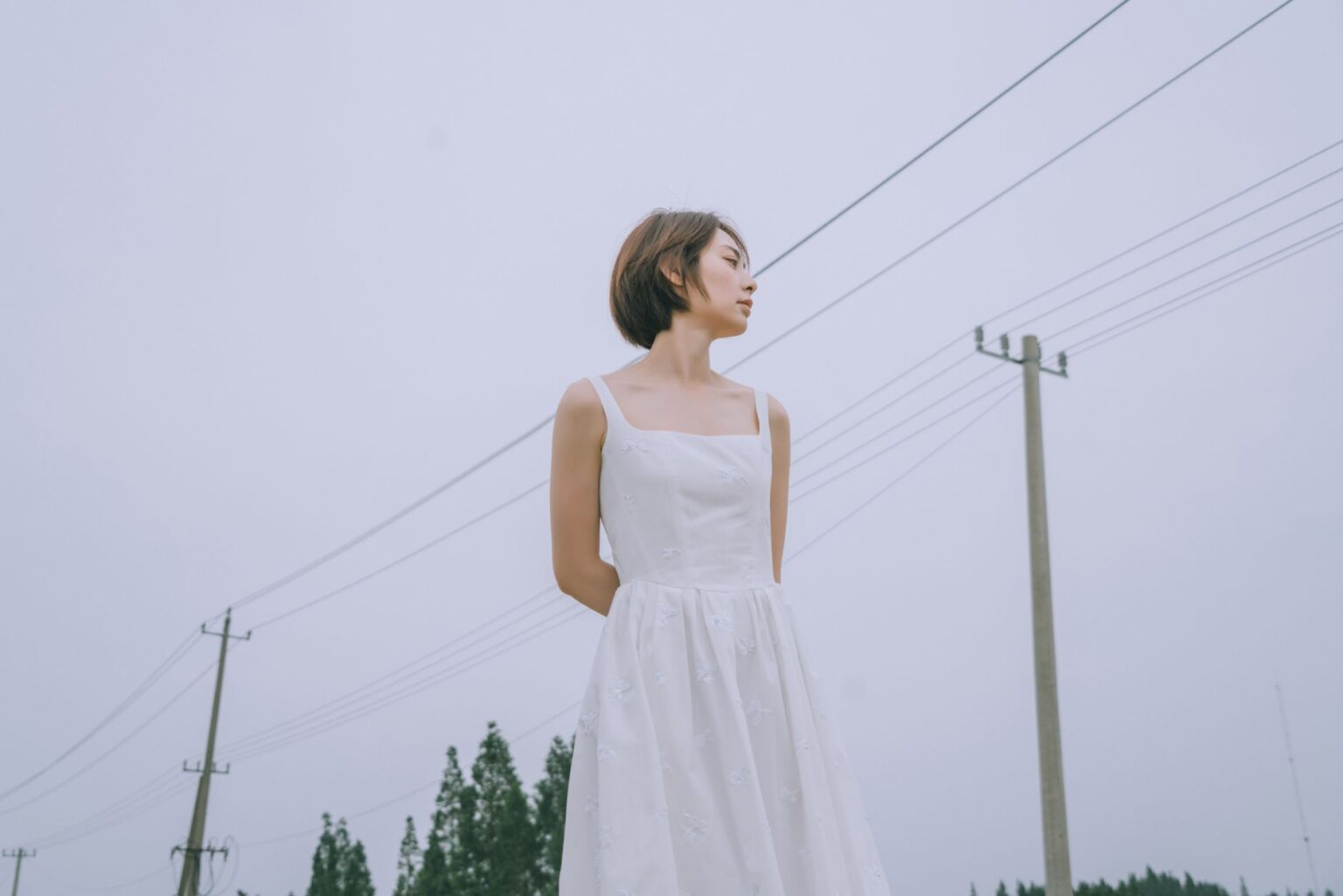 The Broderie Anglaise Dress Is Quietly Edging Out the Sundress A white broderie anglaise dress with eyelet embroidery detail hanging on a rack