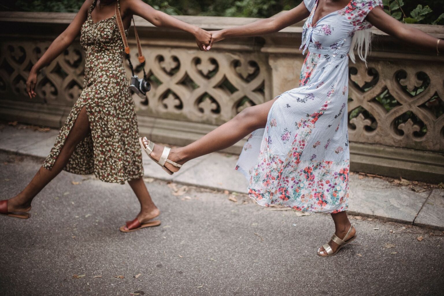 The Ribbon Sandal Is Quietly Edging Out the Toe-Ring Style Close-up of ribbon lace-up sandals tied around the ankle on a woman