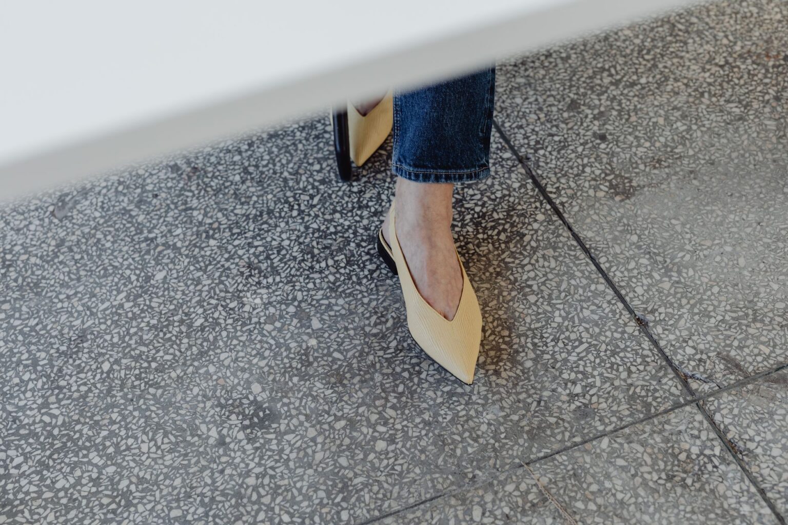 The Pointed-Toe Flat Is Quietly Edging Out the Loafer A pair of sleek pointed-toe flat shoes in black leather on a neutral background