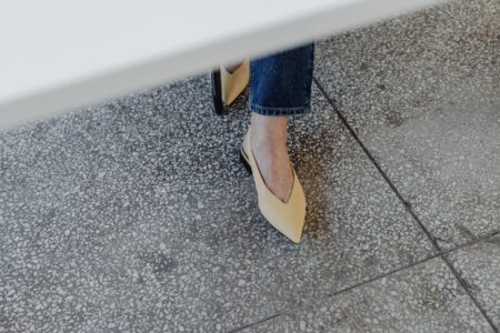The Pointed-Toe Flat Is Quietly Edging Out the Loafer A pair of sleek pointed-toe flat shoes in black leather on a neutral background