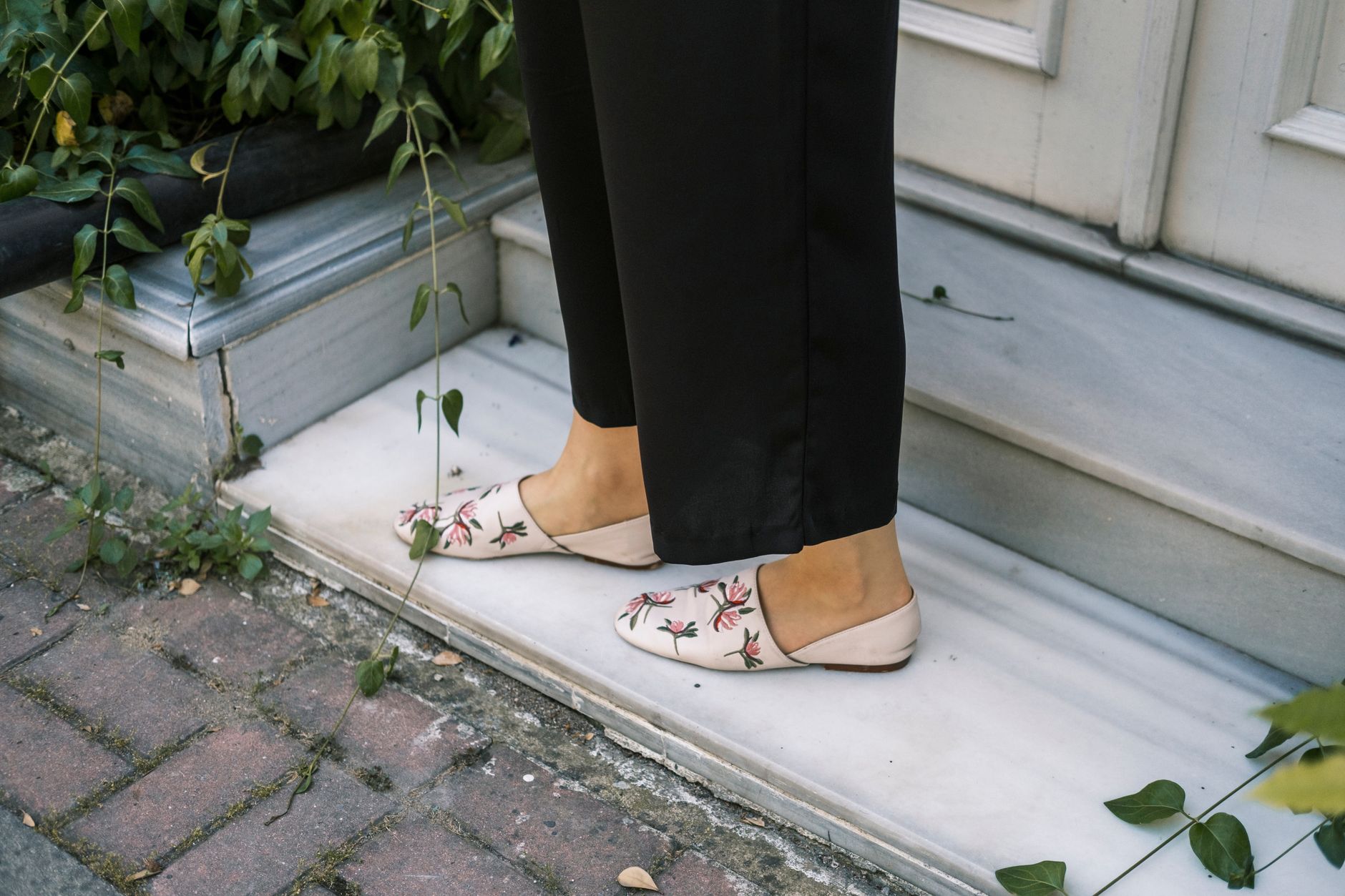 Close-up of women's lace-up flat shoes styled with tailored trousers