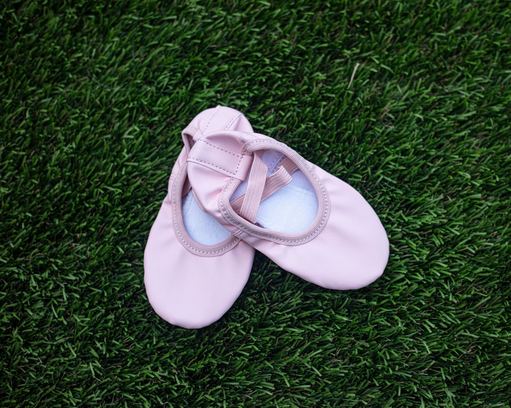 Close-up of a pair of sheer mesh ballet flats on a light background