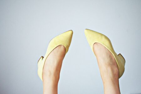 The Pointed-Toe Mule Is Quietly Edging Out the Strappy Kitten Heel A pair of sleek pointed-toe mules in neutral leather on a minimalist background