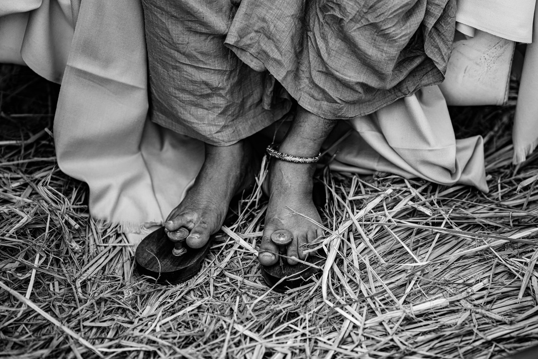 Close-up of raffia woven wedge sandals on a neutral background
