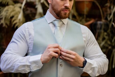 The Broderie Anglaise Waistcoat Is Quietly Edging Out the Tailored Vest A white broderie anglaise waistcoat laid flat, showing delicate eyelet embroidery detail