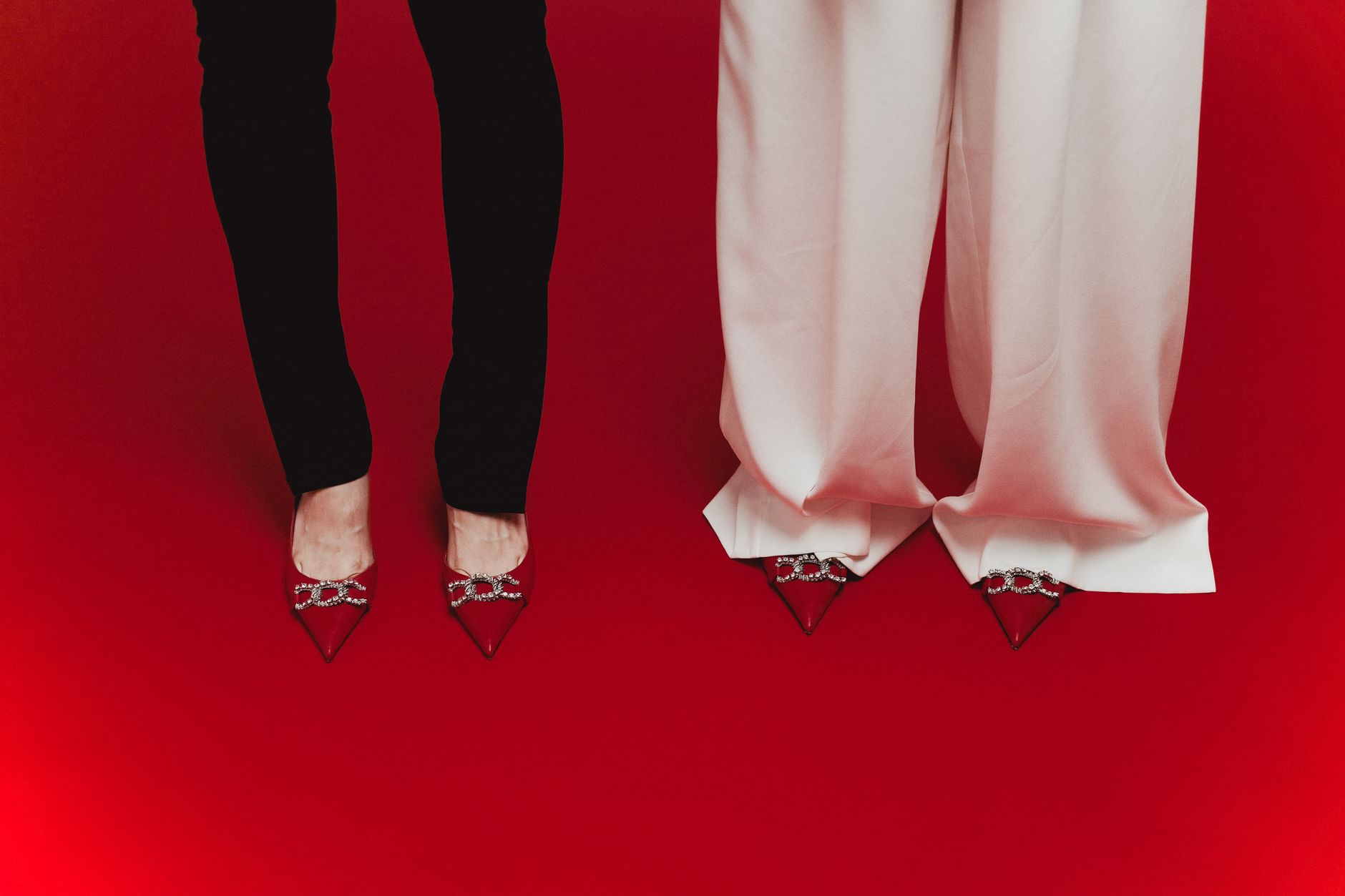 Editorial flat lay of women's flats styled with tailored trousers