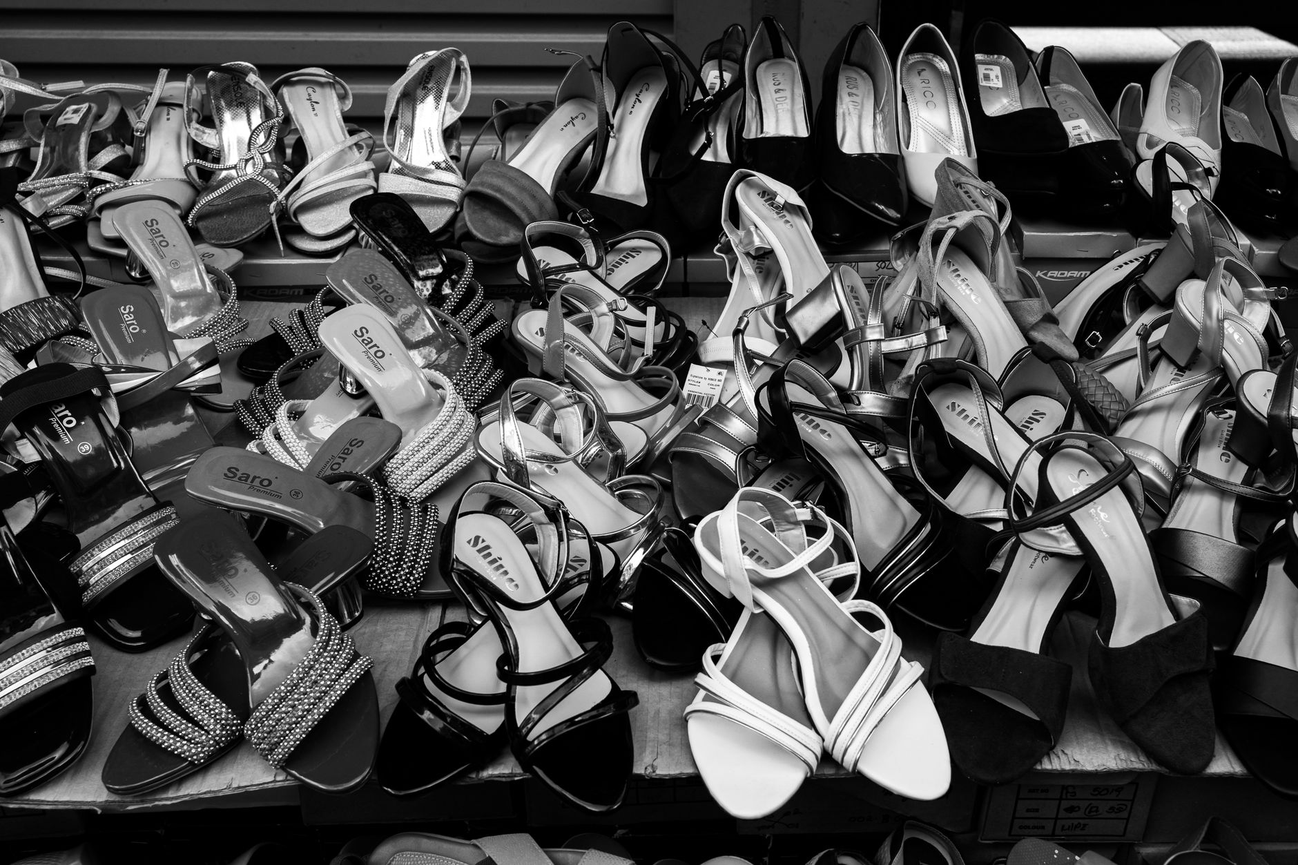 A selection of flat sandals in various styles laid out on a neutral surface