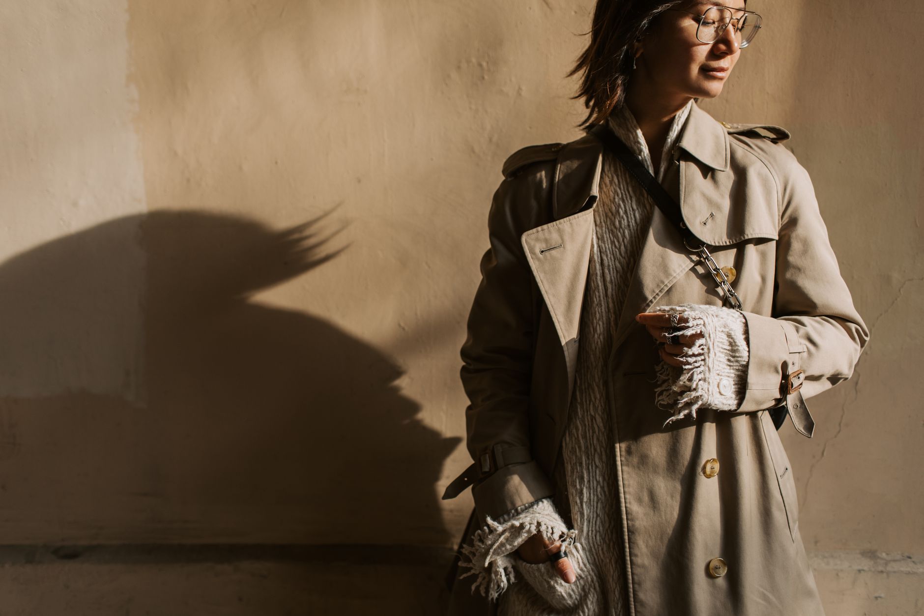 A woman wearing a layered summer outfit with a textured waistcoat over a white shirt