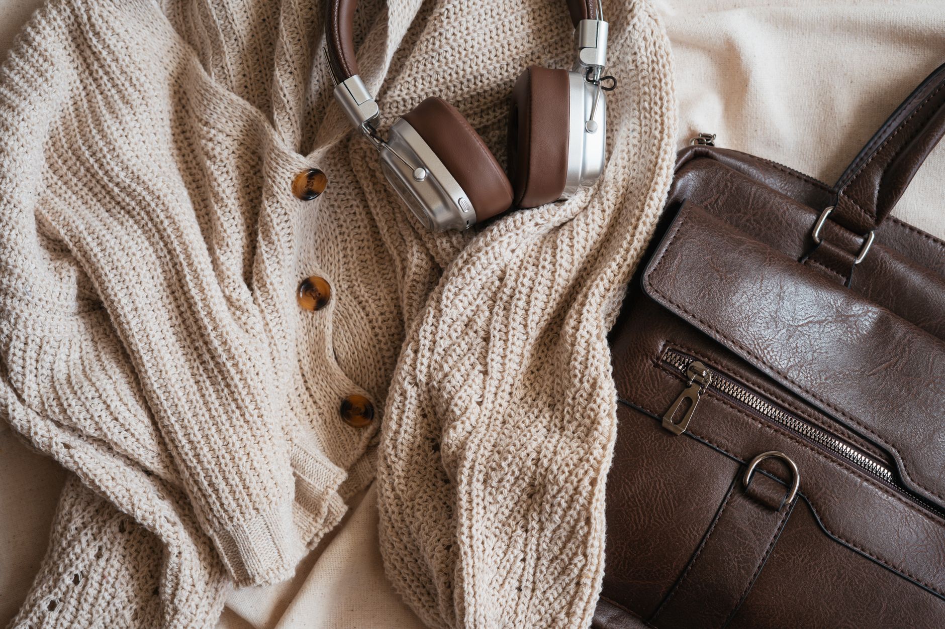 Assortment of natural leather accessories including belts in cognac and tobacco tones